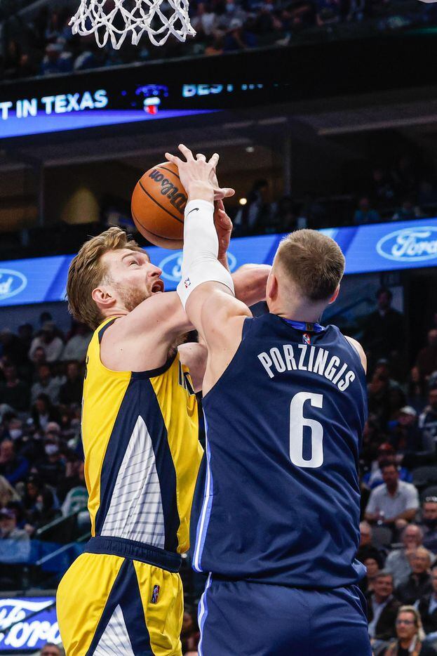 Dallas Mavericks center Kristaps Porzingis (6) blocks a shot by Indiana Pacers forward Domantas Sabonis (11) during a game at the American Airlines Center in Dallas on Saturday, January 29, 2022.