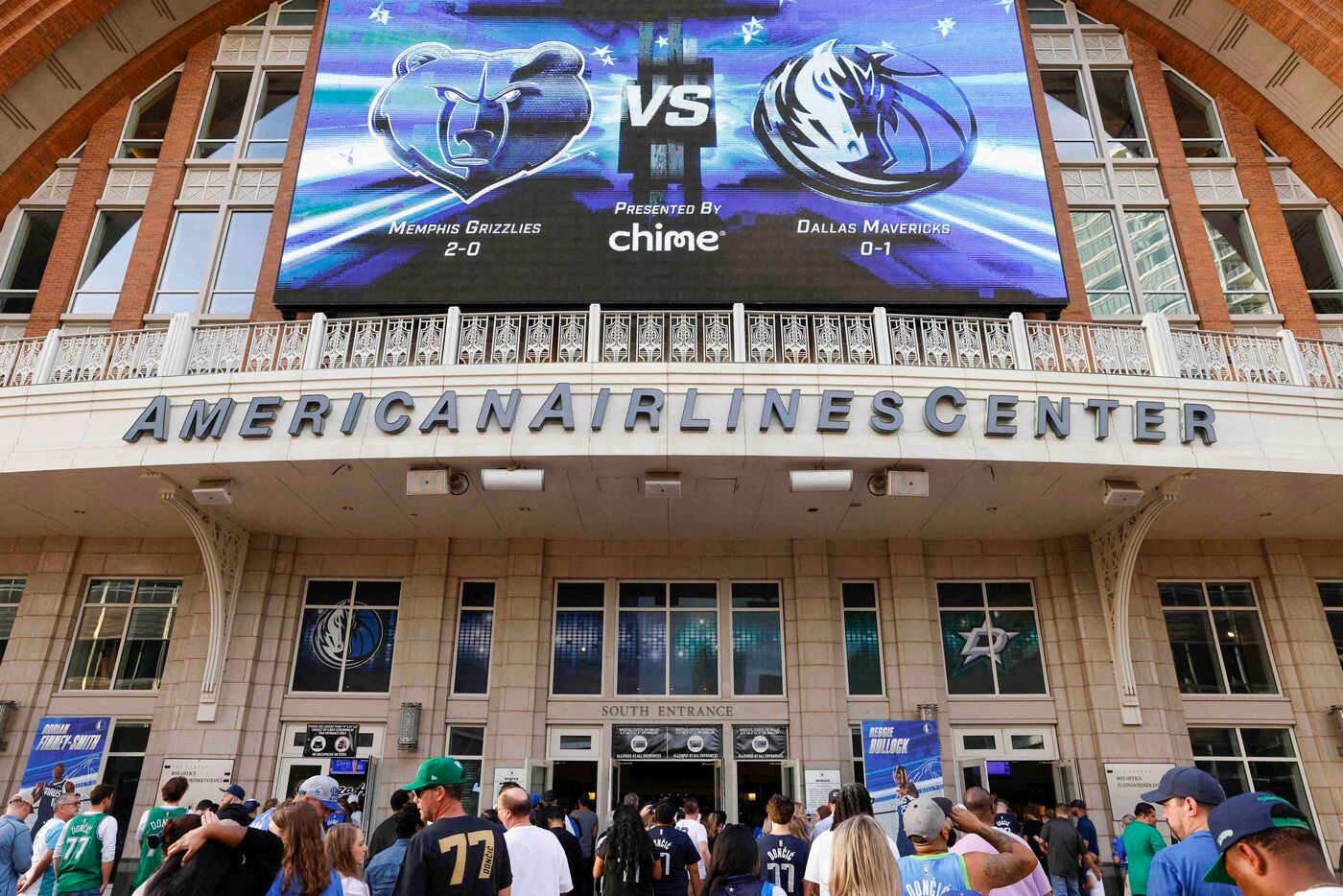 Fans wait in line before the Mavs home opener at the American Airlines Center on Saturday,...