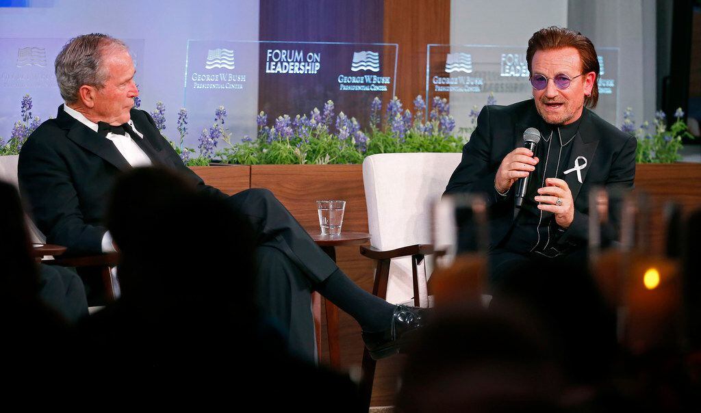 Former President George W. Bush listens as U2 lead singer Bono speaks after receiving the...