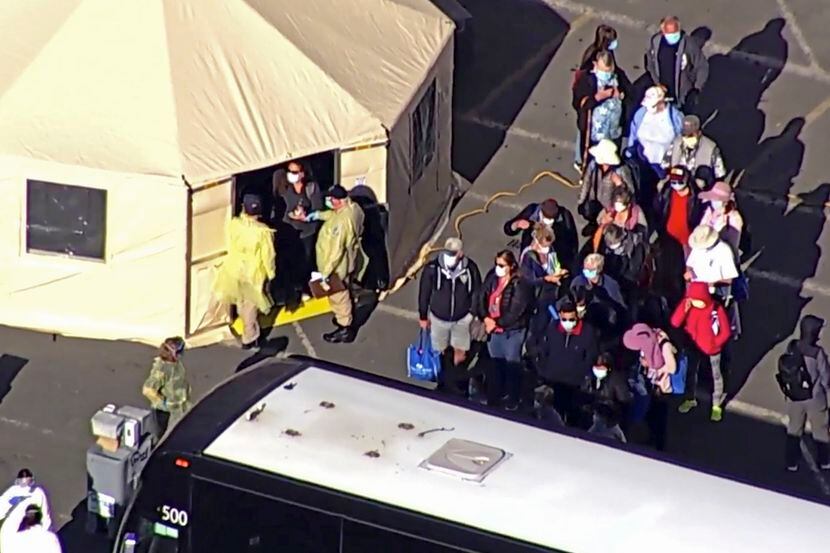 On March 10, passengers waited to board buses after leaving the Grand Princess cruise ship...