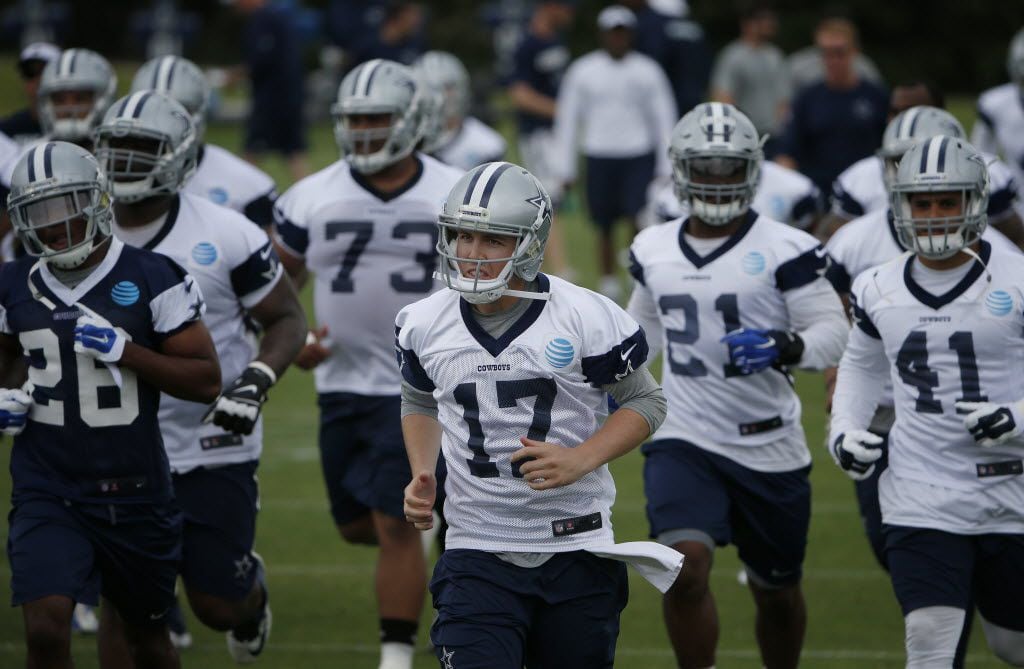 FILE - Dallas Cowboys quarterback Kellen Moore (17) runs on the field during organized team...