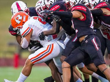 Rockwall running back  Zach Hernandez (2) is brought down by the Rockwall-Heath defense...