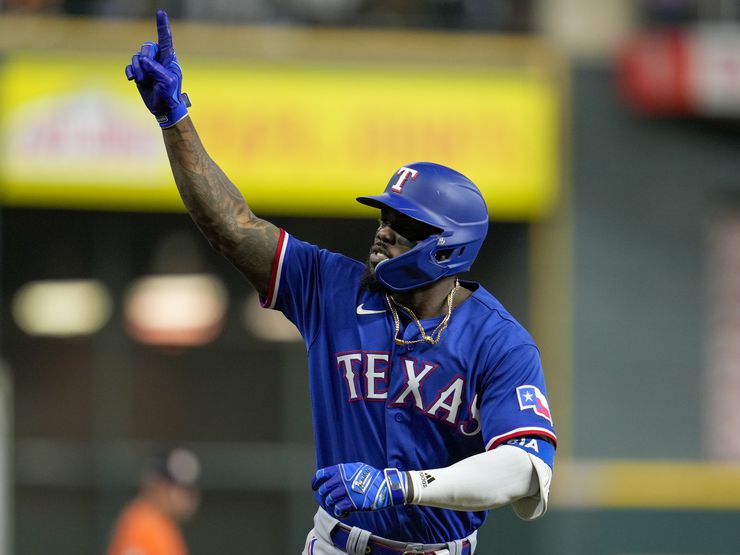 Texas Rangers' Corey Seager, left, Adolis Garcia, center, and Marcus Semien  celebrate the team's 5-2 win over the Chicago White Sox after a baseball  game Monday, June 19, 2023, in Chicago. (AP