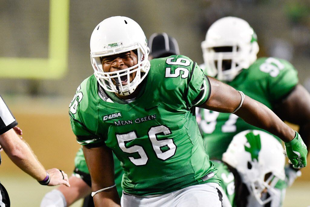 North Texas senior defensive end Malik Dilonga (56) screams and celebrates after he helps...
