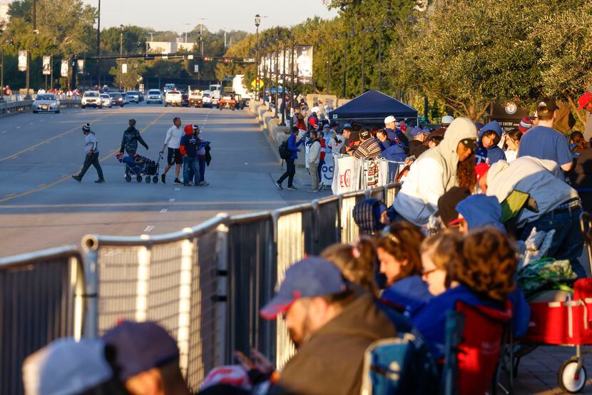 Texas Rangers fans wait by the barricade early morning ahead of a World Series baseball...