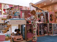 Jori Smith, 4, visiting from Austin, explores the first official American Girl dollhouse...