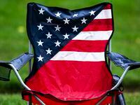 Rainwater filled the seat of a chair after the 4thFest parade in Coralville, Iowa, was...
