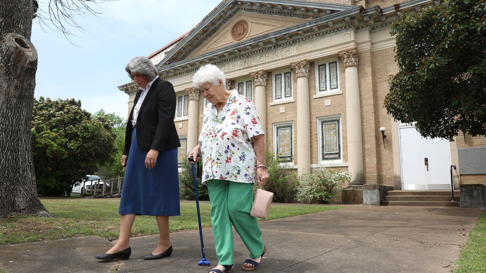 Pastor Julie Adkins walks with Maurine Powell (right), a lifelong member of Milford...