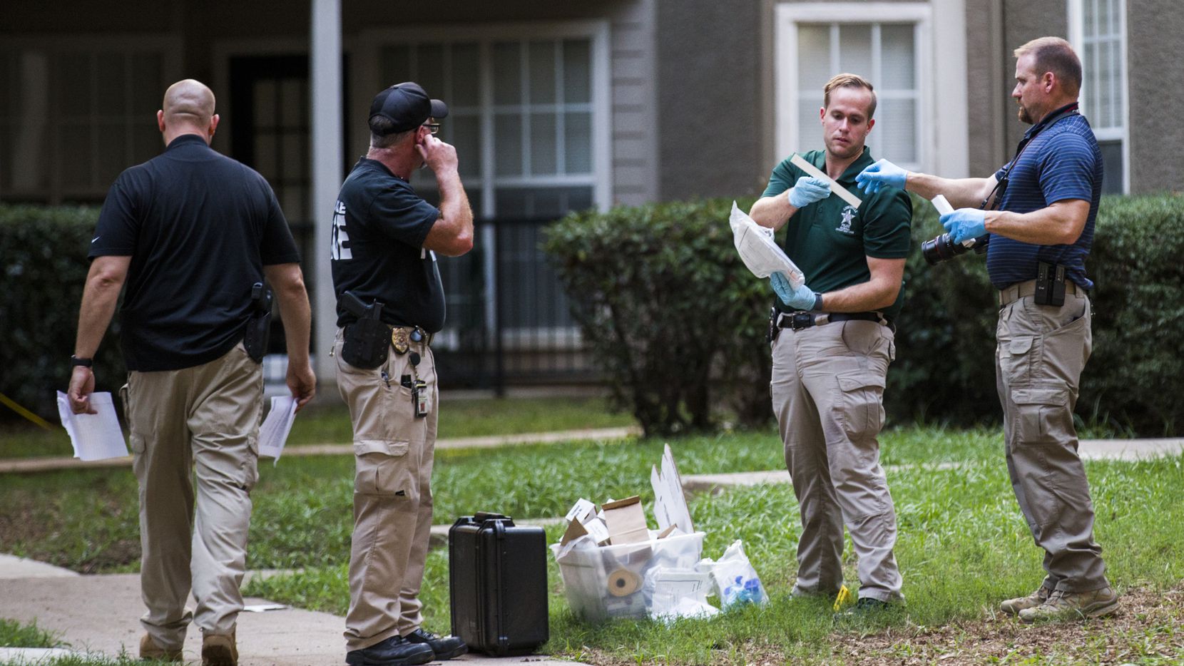 Lewisville police officers investigate a scene where a man fatally stabbed a 16-month-old  on Sunday.