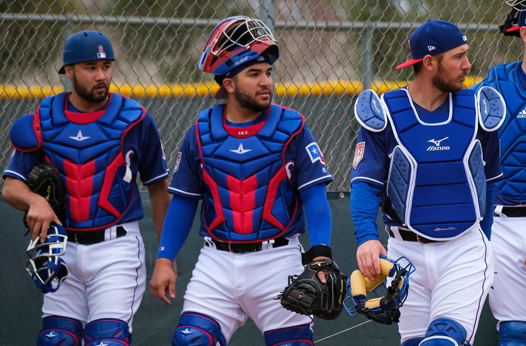 Texas Rangers catchers (from left) Isiah Kiner-Falefa, Jose Trevino and Jeff Mathis prepare...