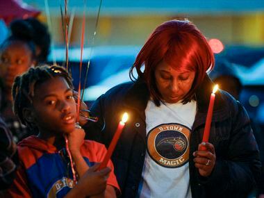 Lashundra Gee stands with her son Omariyon Wallace, 11, during a balloon release in memory...