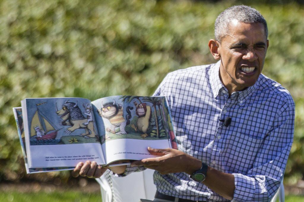 President Barack Obama reads the book "Where the Wild Things Are" to a group of children...
