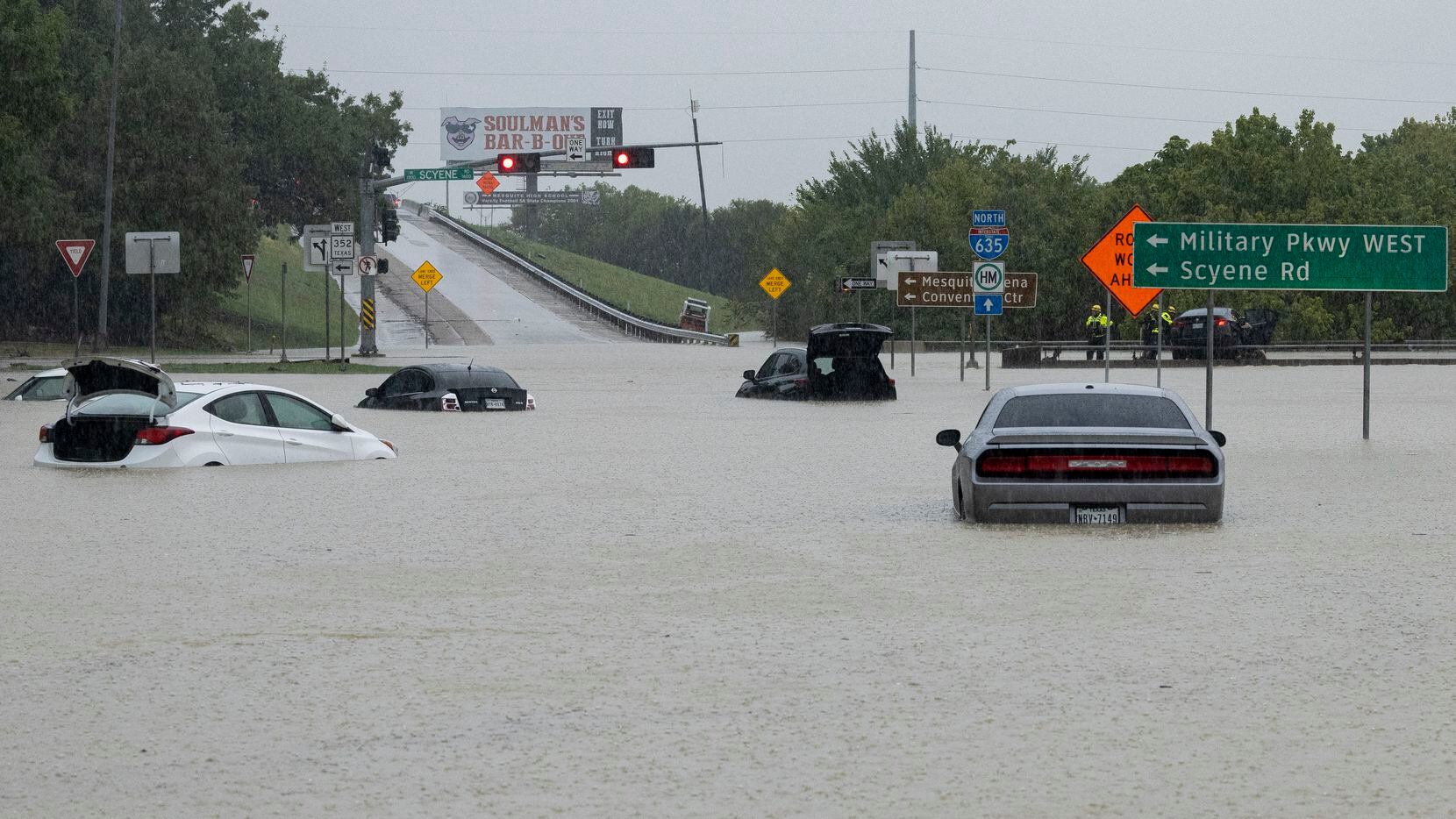 Stalled cars sit abandoned on the flooded Interstate 635 Service Road on Monday, Aug. 22,...