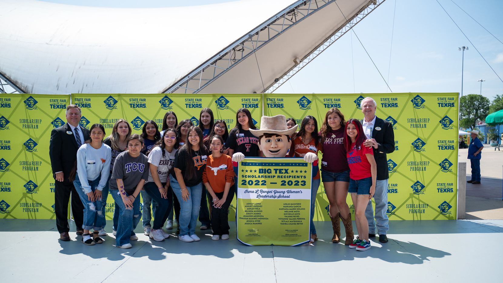 Large group of students stand with a Big Tex Scholarship Recipients list sign at the State...