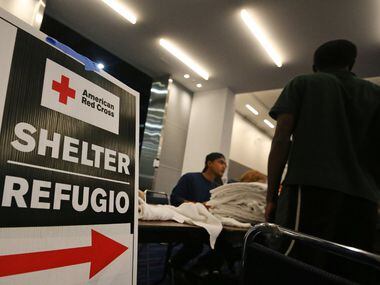 Signs show the way for the Red Cross shelter at the George Brown Convention Center in ...