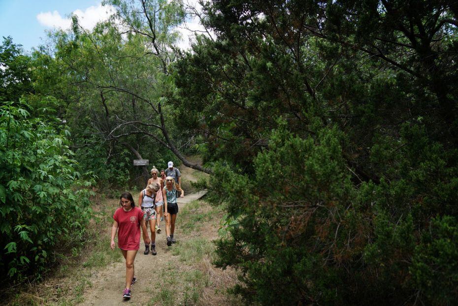 Students from Richardson's J.J. Pearce High School hike at Cedar Hill State Park during a...