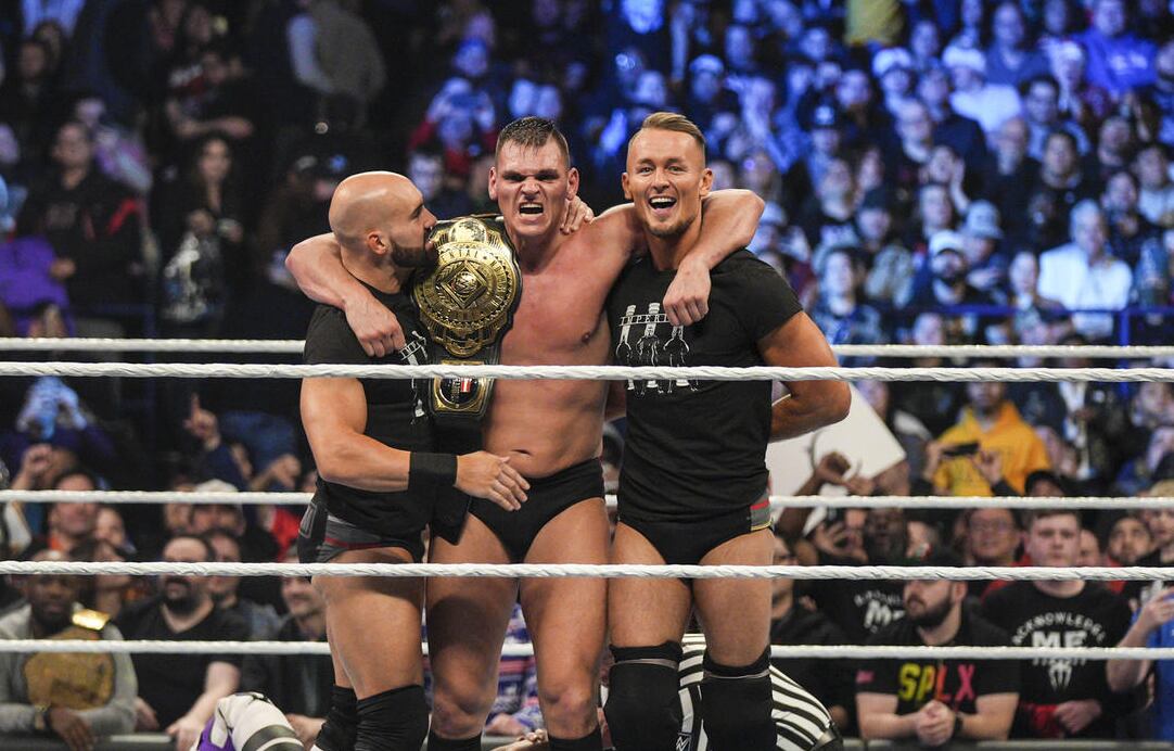 WWE's Gunther (middle) celebrates with Giovanni Vinci (left) and Ludwig Kaiser (right) after...