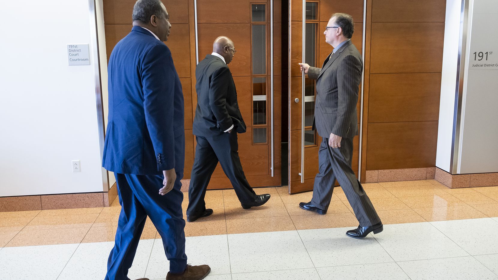 Chris Caso, interim Dallas city attorney (right), holds the door for Dallas council member Tennell Atkins and State Sen. Royce West to enter a hearing at Judge Gena Slaughter's courtroom at the  George L. Allen, Sr. Courts Building on Thursday, March 21, 2019. A hearing was held Thursday on the fate of what has become known as Shingle Mountain in southeast Dallas.