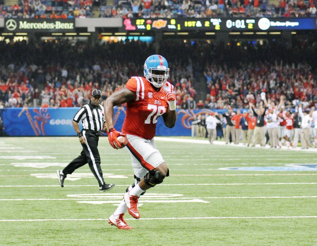 Mississippi offensive lineman Laremy Tunsil (78) runs two yards for a touchdown as time expires in the first half of the Sugar Bowl NCAA college football game against Oklahoma, Friday, Jan. 1, 2016 in New Orleans. (Bruce Newman/The Oxford Eagle via AP)  NO SALES; MANDATORY CREDIT