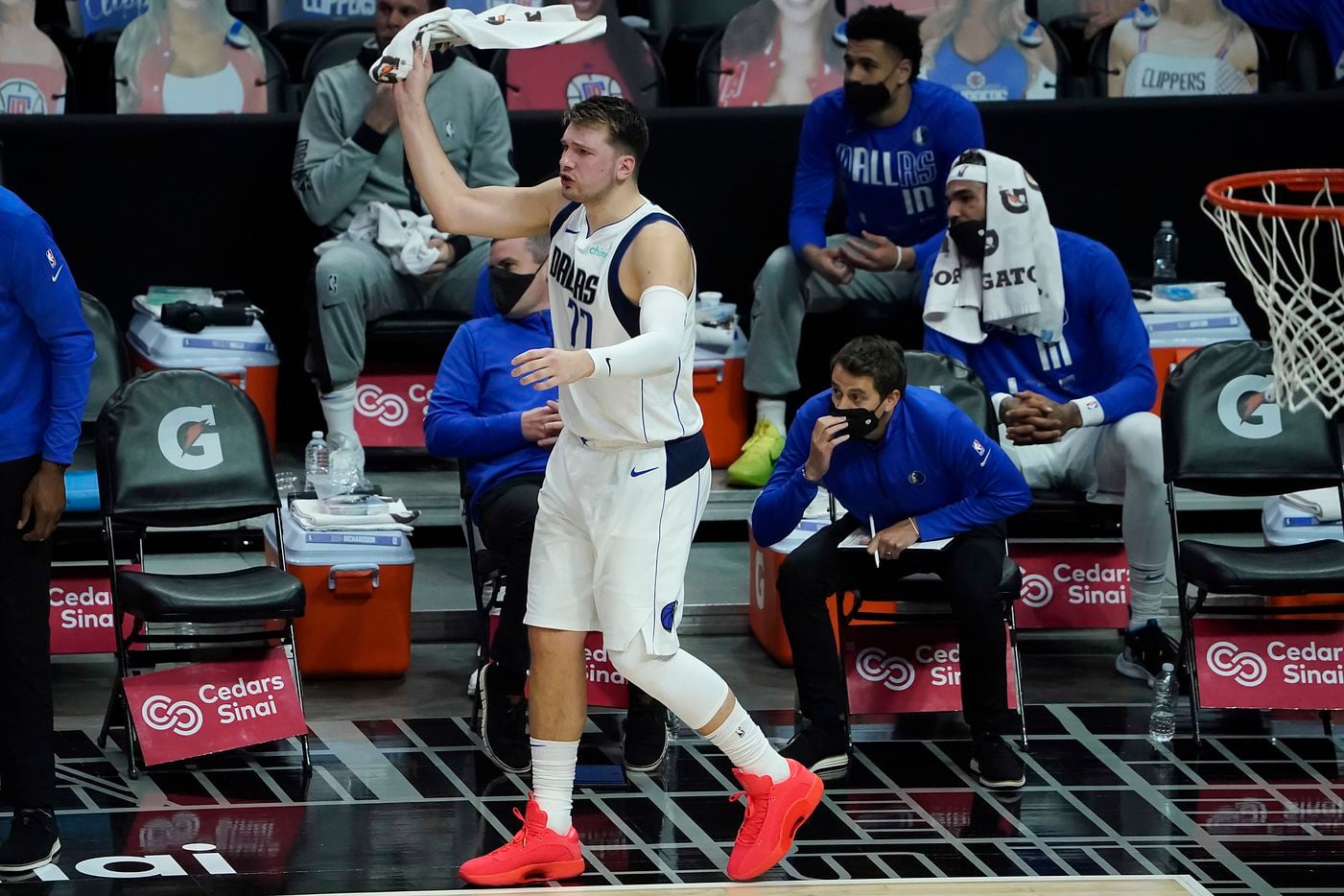Dallas Mavericks guard Luka Doncic (77) cheers from the bench during the first half of an NBA playoff basketball game against the LA Clippers at Staples Center on Tuesday, May 25, 2021, in Los Angeles.