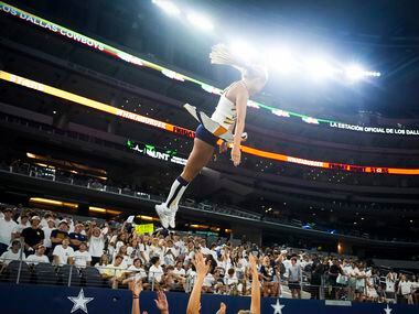 A Highland Park cheerleader is tossed into the air during the second half of a high school...