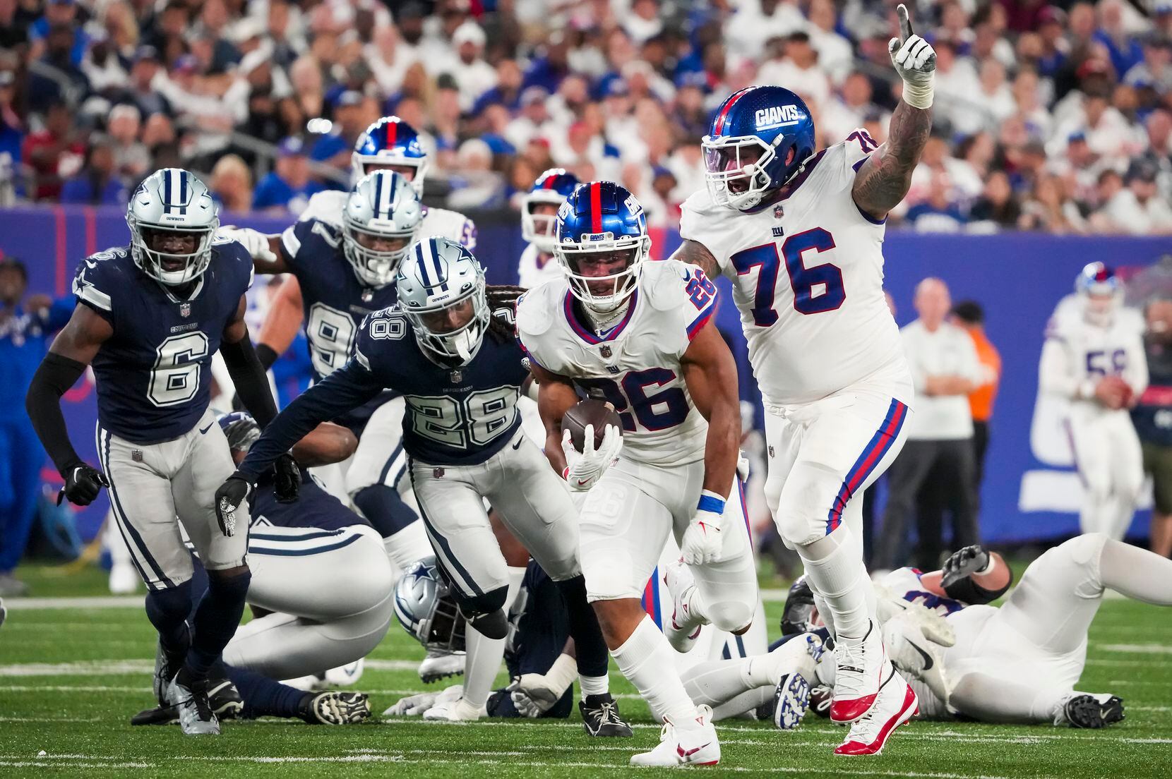New York Giants running back Saquon Barkley (26) gets past Dallas Cowboys safety Malik...