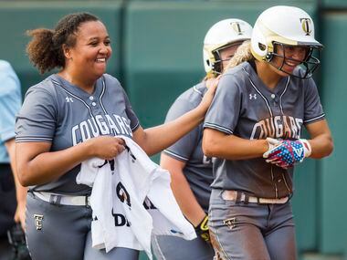 The Colony's Jayda Coleman (10, right) celebrates a run with pitcher Karlie Charles (29)...