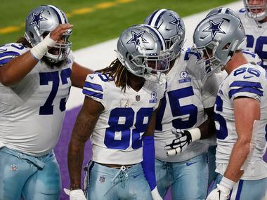 Dallas Cowboys wide receiver CeeDee Lamb (88) celebrates with teammates after catching a 4-yard touchdown pass during the first half of an NFL football game against the Minnesota Vikings, Sunday, Nov. 22, 2020, in Minneapolis. (AP Photo/Bruce Kluckhohn)
