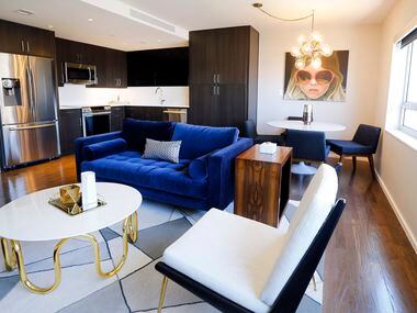 The open floor plan of kitchen, dining and leisure is pictured in a model apartment in the...