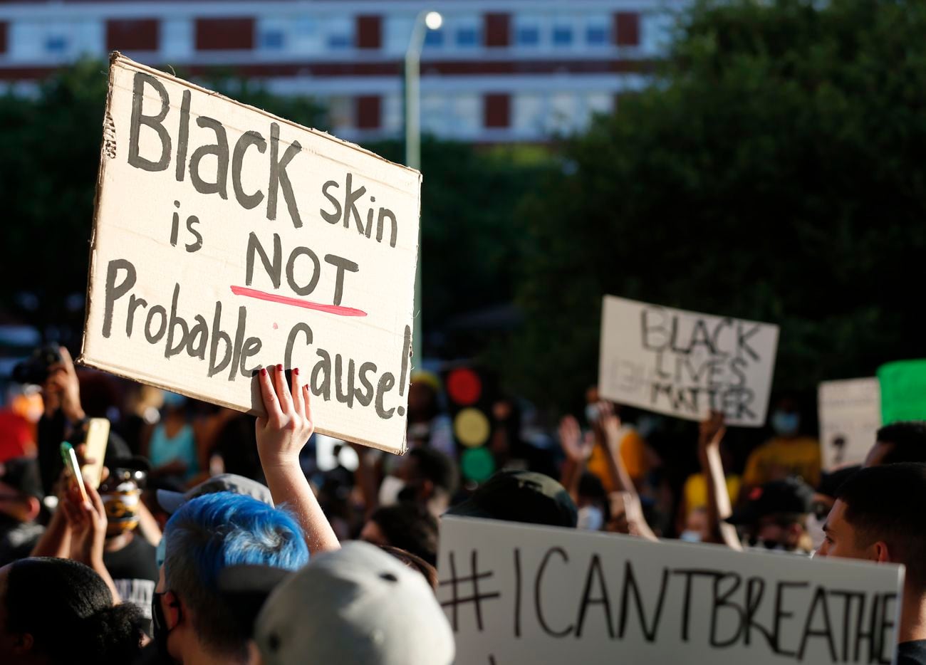 Protesters rally during a demonstration against police brutality in front of Dallas Police...