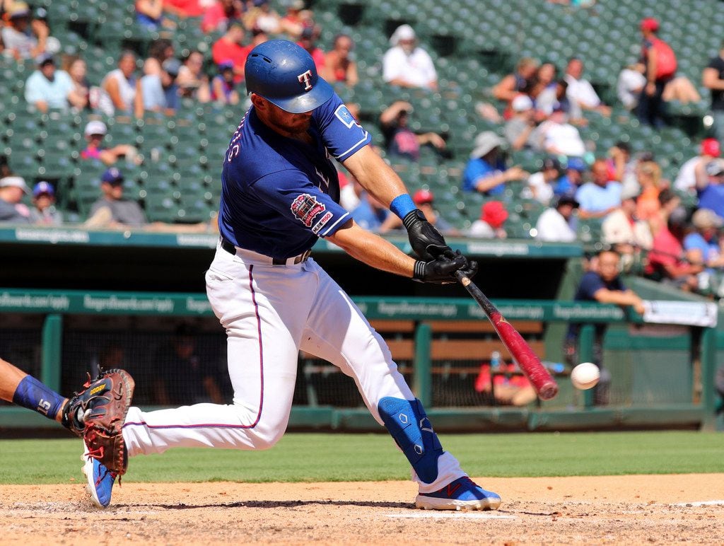 Texas Rangers' Jeff Mathis hits a two-run single in the third inning of a baseball game...