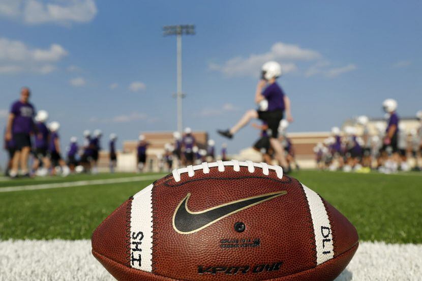 Players warm up on the first day of football practice in Frisco, Texas on Monday, August 4,...