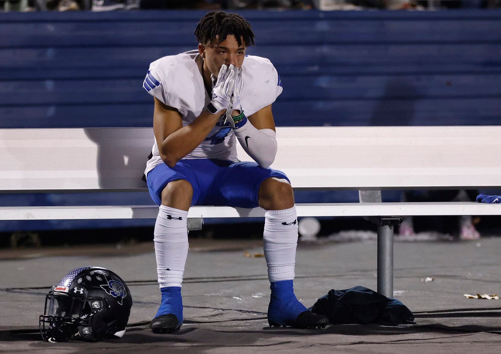 Mansfield Summit senior wide receiver Kobe Russell (14) sits alone on the bench following...