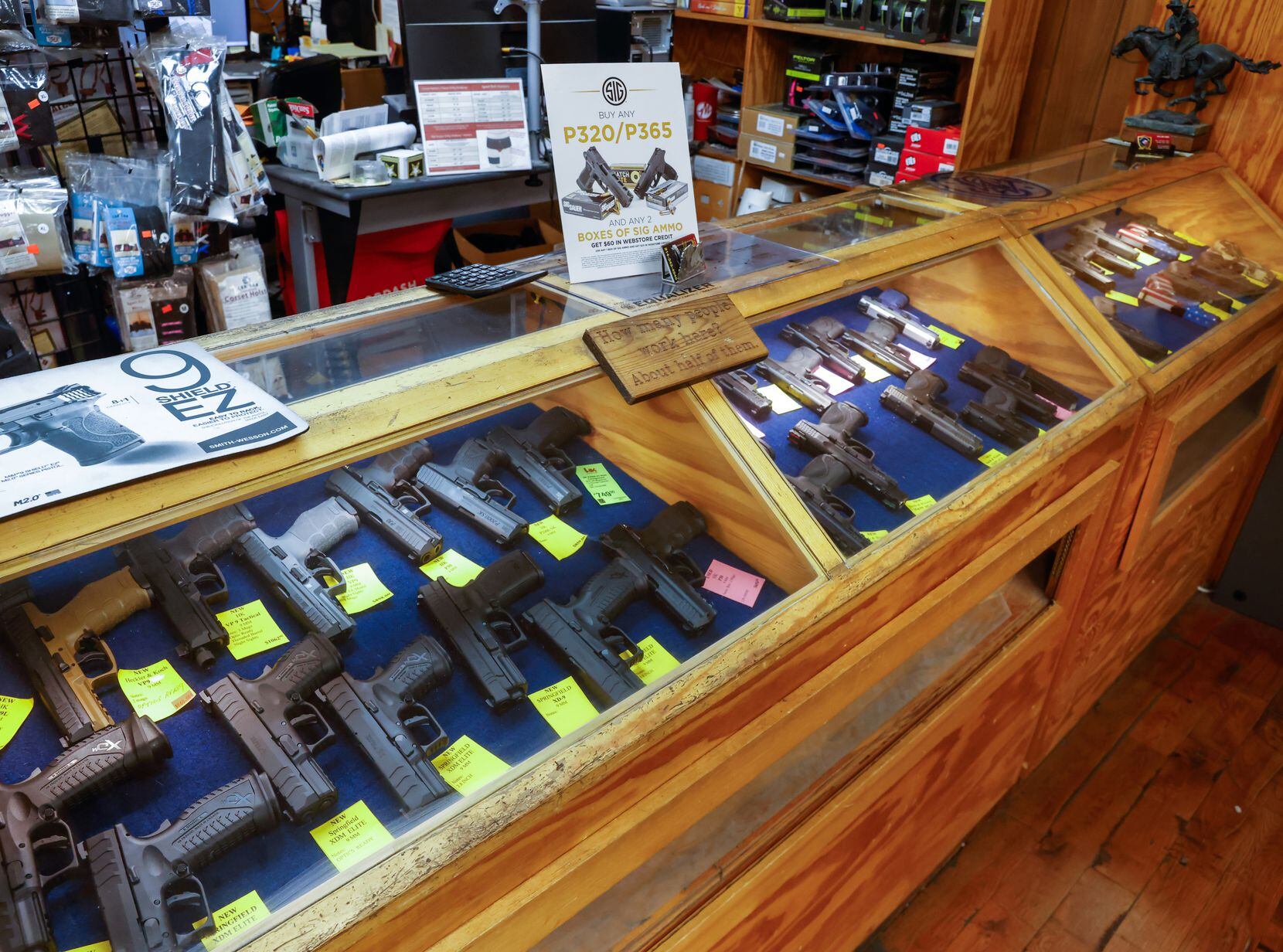 An array of handguns sit on display at TargetMaster, a gun shop and indoor shooting range...