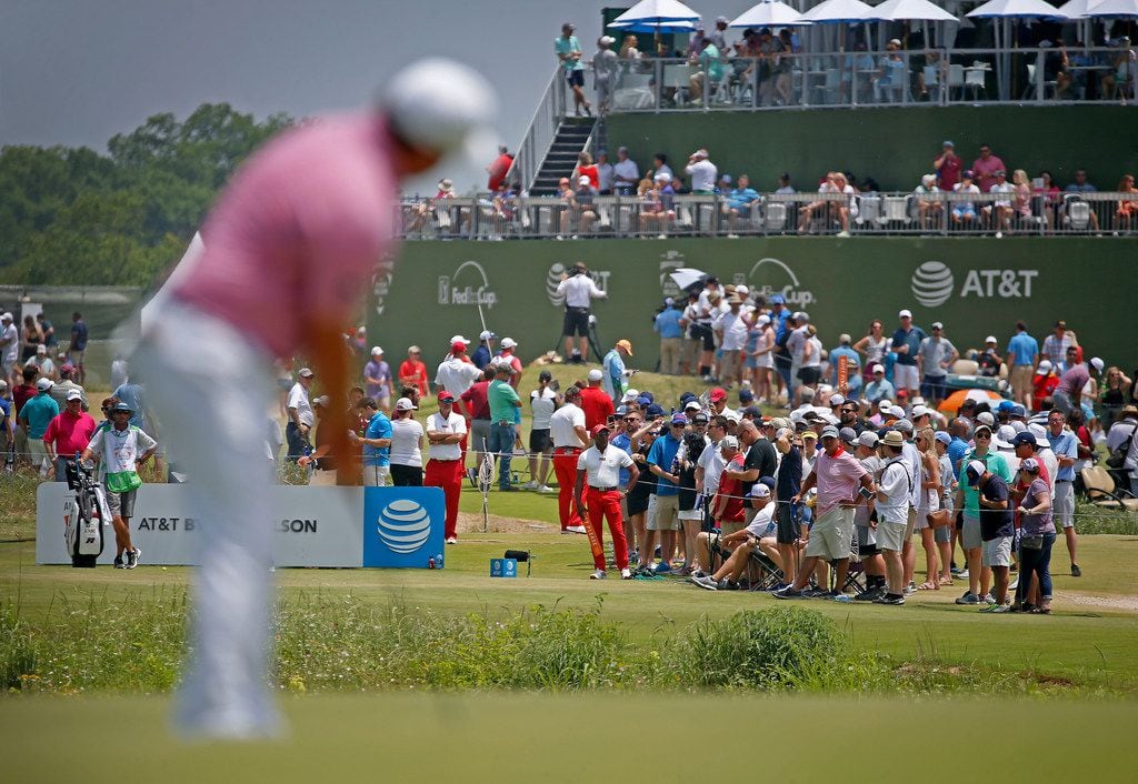 Fans gather near the 17th tee box as Tom Lovelady watches his putt on the 17th green during the third round of AT&T Byron Nelson at Trinity Forest Golf Club in Dallas, Saturday, May 19, 2018.