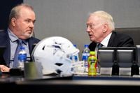Dallas Cowboys owner and general manager Jerry Jones (right) talks with head coach Mike...