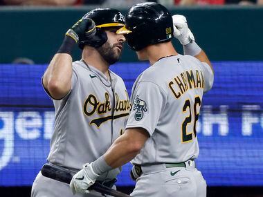 Oakland Athletics designated hitter Mitch Moreland (left) is congratulated on his seventh...