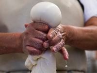 Cheese maker Carmen Lopez forms Mozzarella into a ball of cheese as a group of women prepare a variety of cheese at The Mozzarella Company in Dallas, on Monday, April 05, 2021.