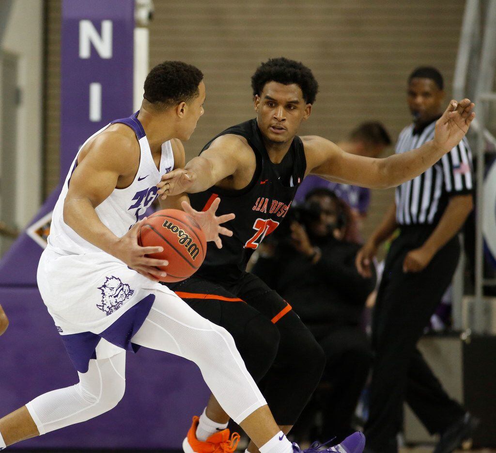 TCU guard Desmond Bane (1) is defended by Sam Houston State forward Kai Mitchell (20) during...