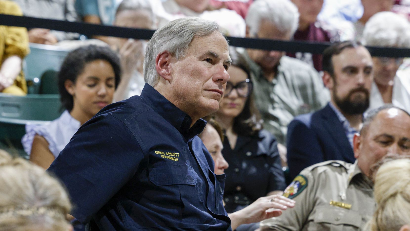 Gov. Greg Abbott listens to a local pastor during a vigil for victims of the Robb Elementary...