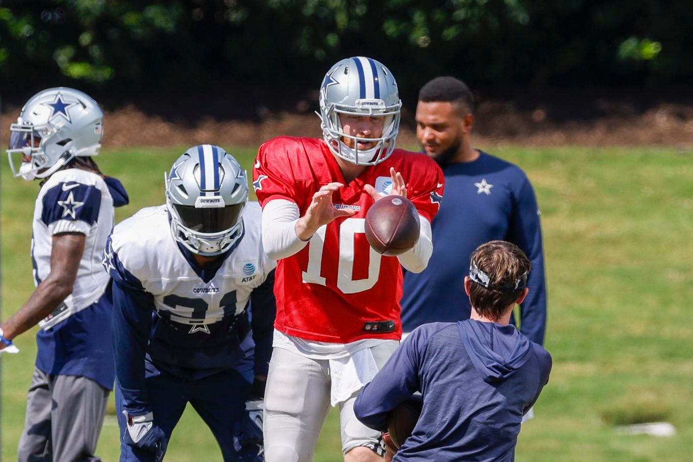 Dallas Cowboys quarterback Cooper Rush (10) takes a snap during a practice at The Star,...