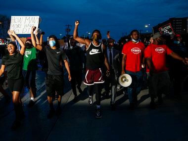 Protesters march to the Margaret Hunt Hill Bridge as they demonstrate against police...