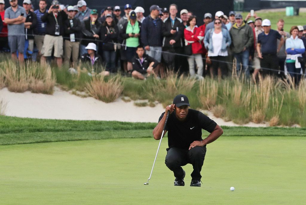 Tiger Woods lined up a putt on the 17th green during the second round of the PGA...