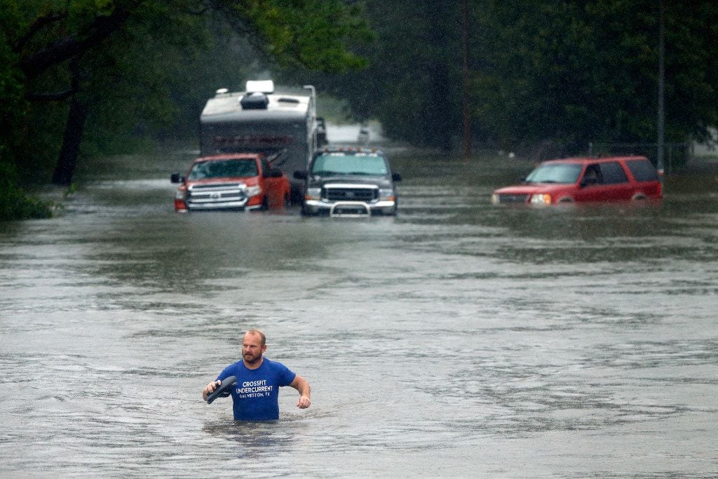 A man vacated his flooded out truck in Dickinson, Texas, Monday, August 28, 2017 after...