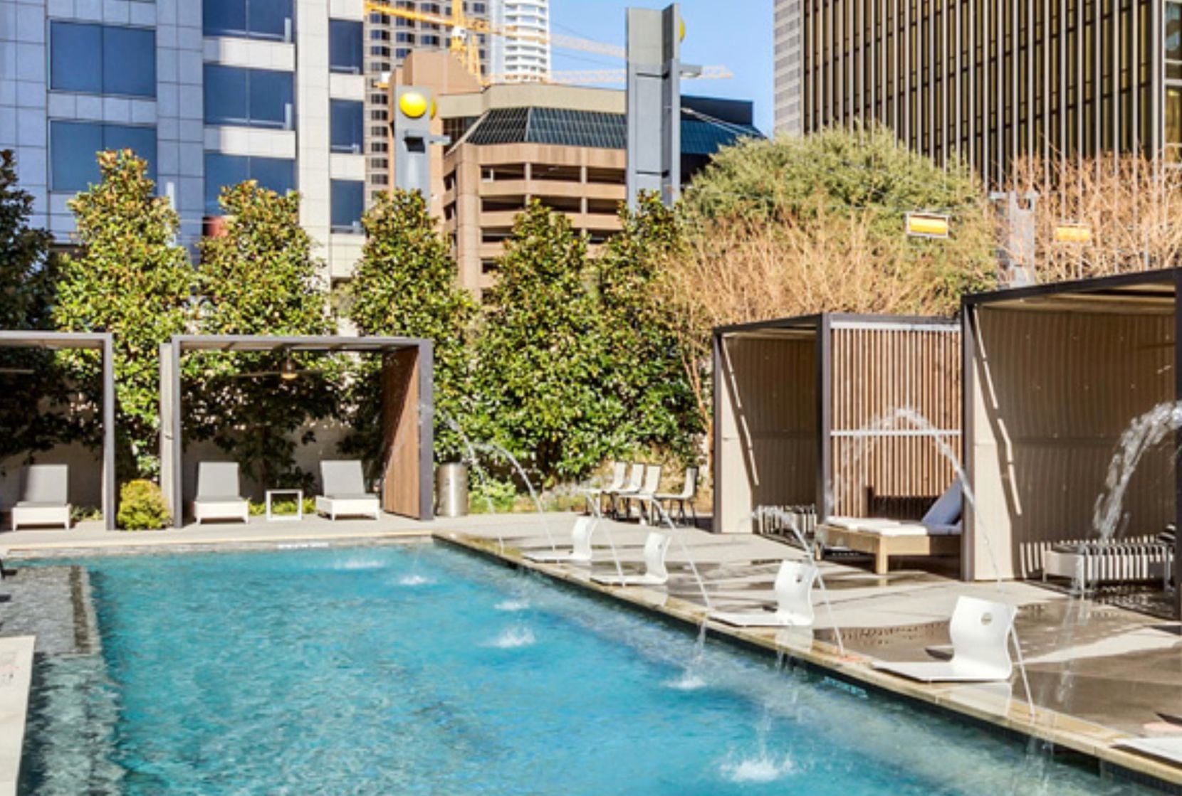 The 276-unit luxury rental community at One Dallas Center includes a ground floor swimming...
