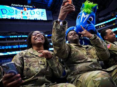 Staff Sgt. Beonka Robinson and Staff Sgt. Brandon Thweatt take selfies with Dallas Mavericks...