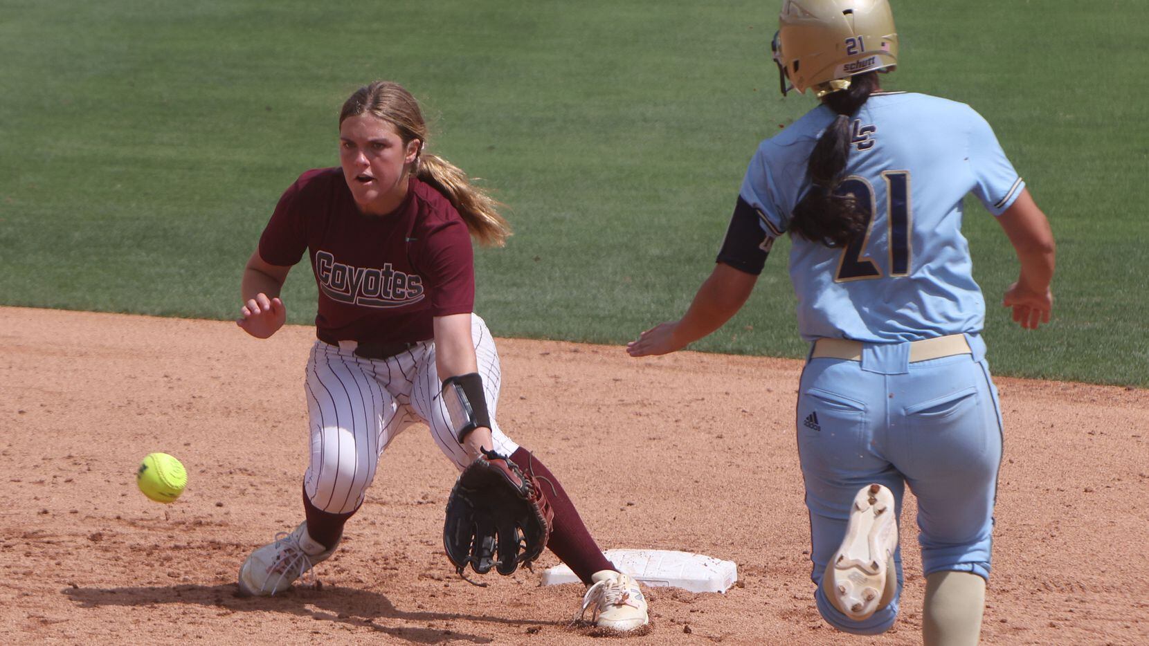 Frisco Heritage shortstop Ahna Van meter (5) takes the thrown 2nd base in an attempt to stop...