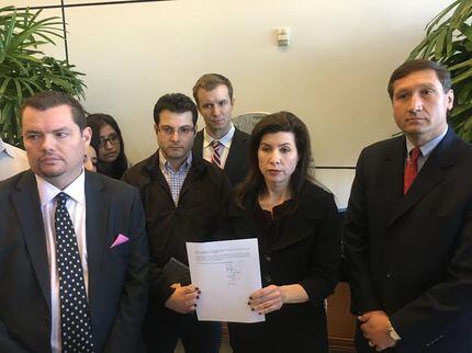 Angela Hunt, center, holds a copy of the Freedom of Information Act lawyers submitted during...