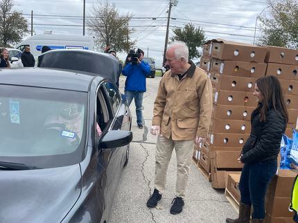 U.S. Sen. John Cornyn, shown helping with food distribution at a drive-through center in...