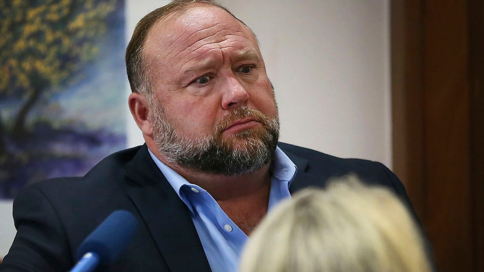 Conspiracy theorist Alex Jones attempts to answer questions Wednesday about his emails...